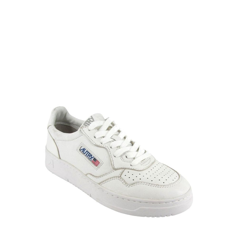 Autry low-top sneakers in white leather with a perforated toe box, white laces, and side logo patch.