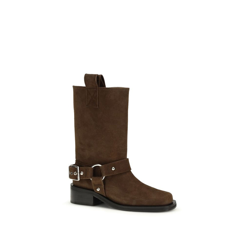 Ganni brown suede mid-calf pull-on boot with silver hardware, buckled harness strap, and a low block heel.
