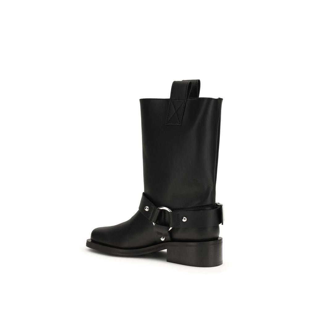 Black calf leather flat boots by Ganni, featuring a mid-calf silhouette, pull tab, and a buckled strap with silver ring.