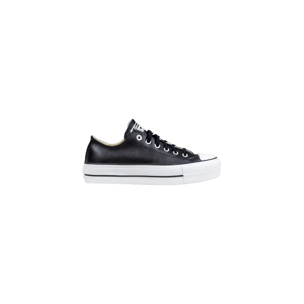 Converse low-top sneakers in black leather with matching black laces and a thick white platform sole.