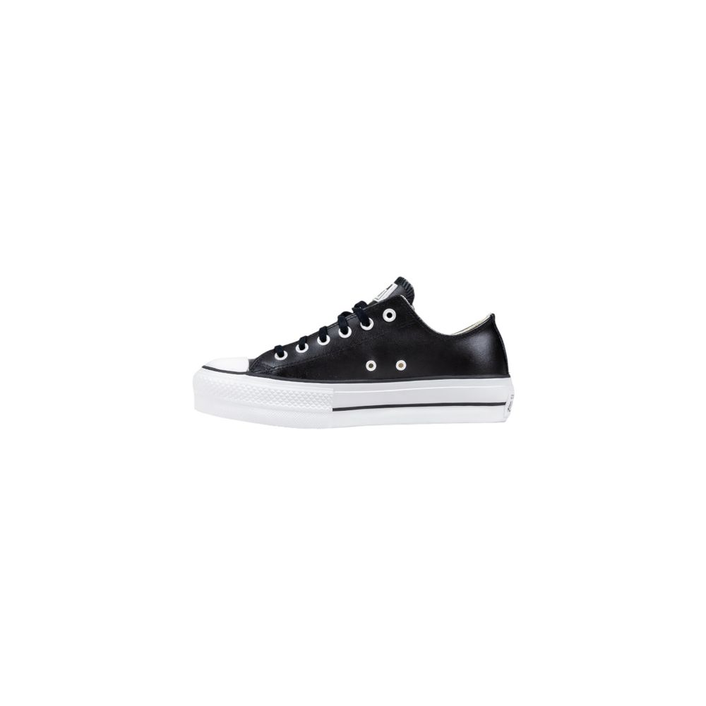 Converse low-top sneakers in black leather with a chunky white platform sole and silver eyelets.