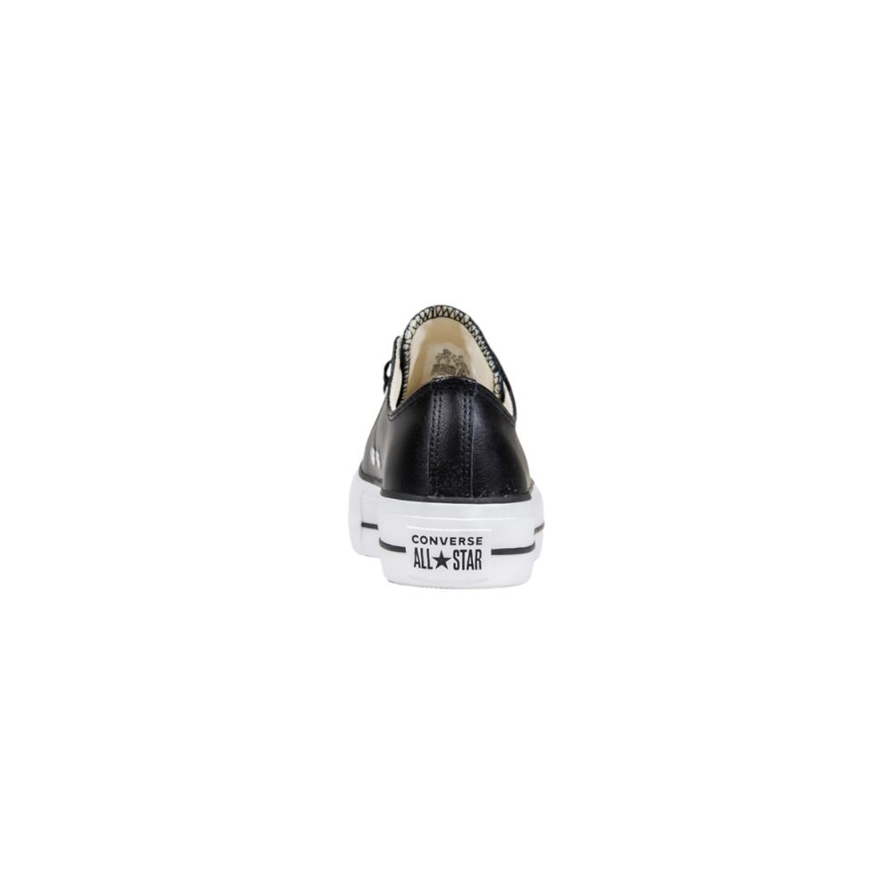 Black leather low-top Converse sneaker viewed from the back, featuring a white platform sole with All Star branding.