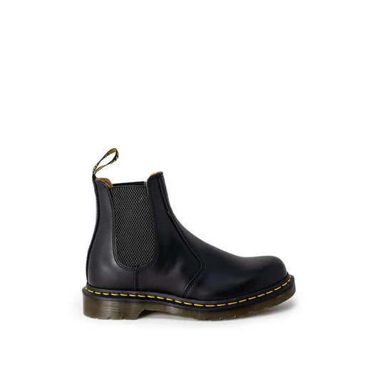 Black leather Chelsea boots with elastic side panels, signature yellow stitching, and a thick lugged sole.