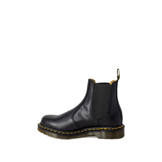 Black leather Dr. Martens Chelsea boot with elastic side panels, yellow welt stitching, and a thick rubber sole.