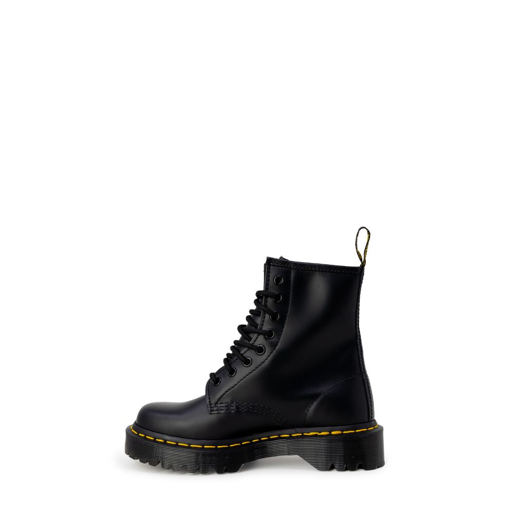 Black leather lace-up boot with a thick lug sole, yellow welt stitching, and a signature heel pull tab.