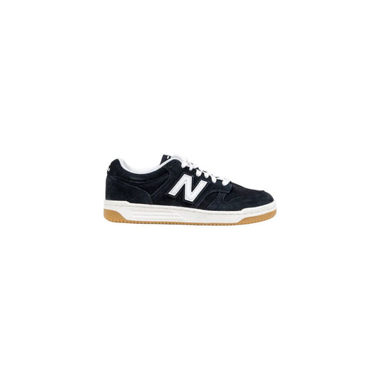 New Balance black suede low-top sneaker with white "N" logo, white laces, and gum rubber outsole.