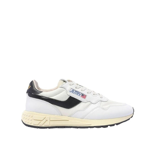 Autry low-top sneakers in white leather with black accents, side logo detail, and a vintage-style cream rubber sole.