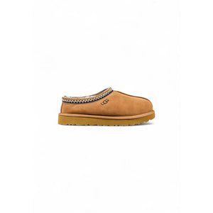 UGG beige suede slip-on shoe with decorative patterned collar trim and embossed logo.