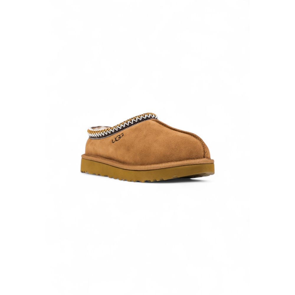 UGG beige suede slip-on shoe with decorative braided collar trim and thick rubber sole.