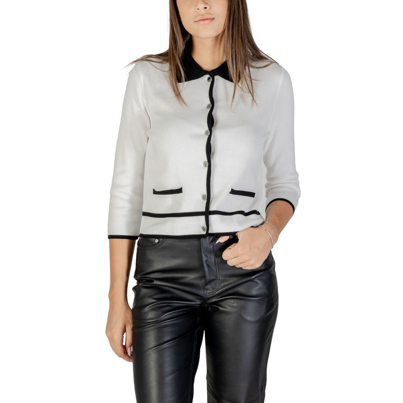 White viscose cardigan with black trim, lapel collar, buttons, and front pockets worn by a model