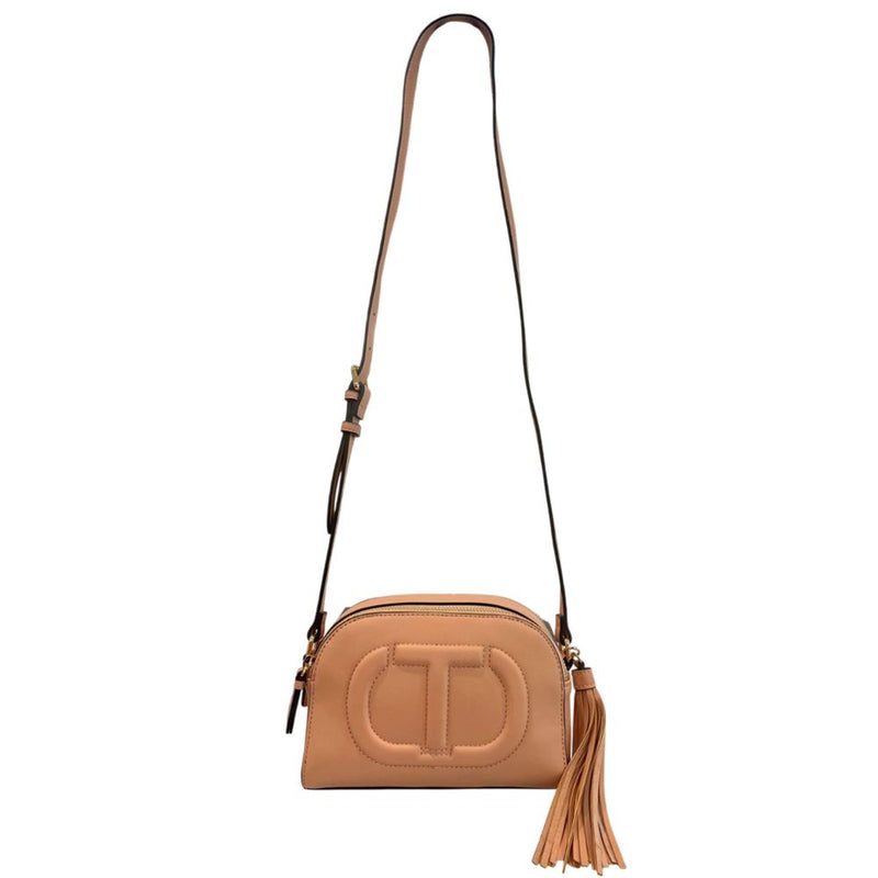 Pink faux leather crossbody bag with a long strap, tassel, and embossed front logo