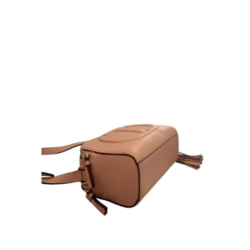 Pink faux leather crossbody bag with zipper and tassel detail