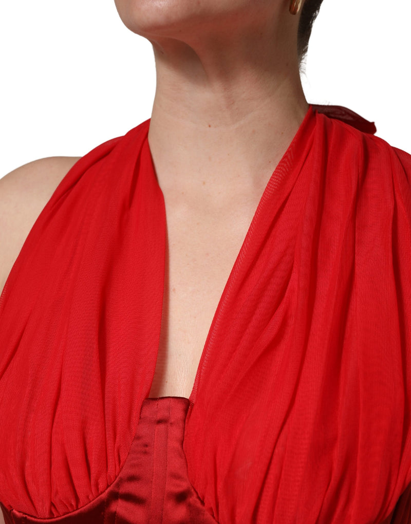 Red halter dress with a sheer draped overlay and a satin corset bodice
