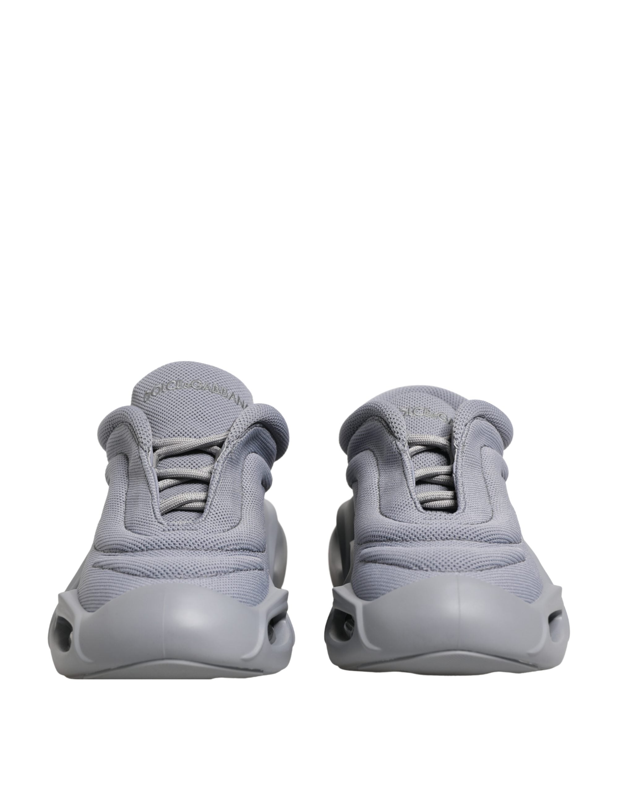 Dolce & Gabbana gray low-top sneakers in mesh and rubber, featuring a slip-on style with a chunky, futuristic sole.