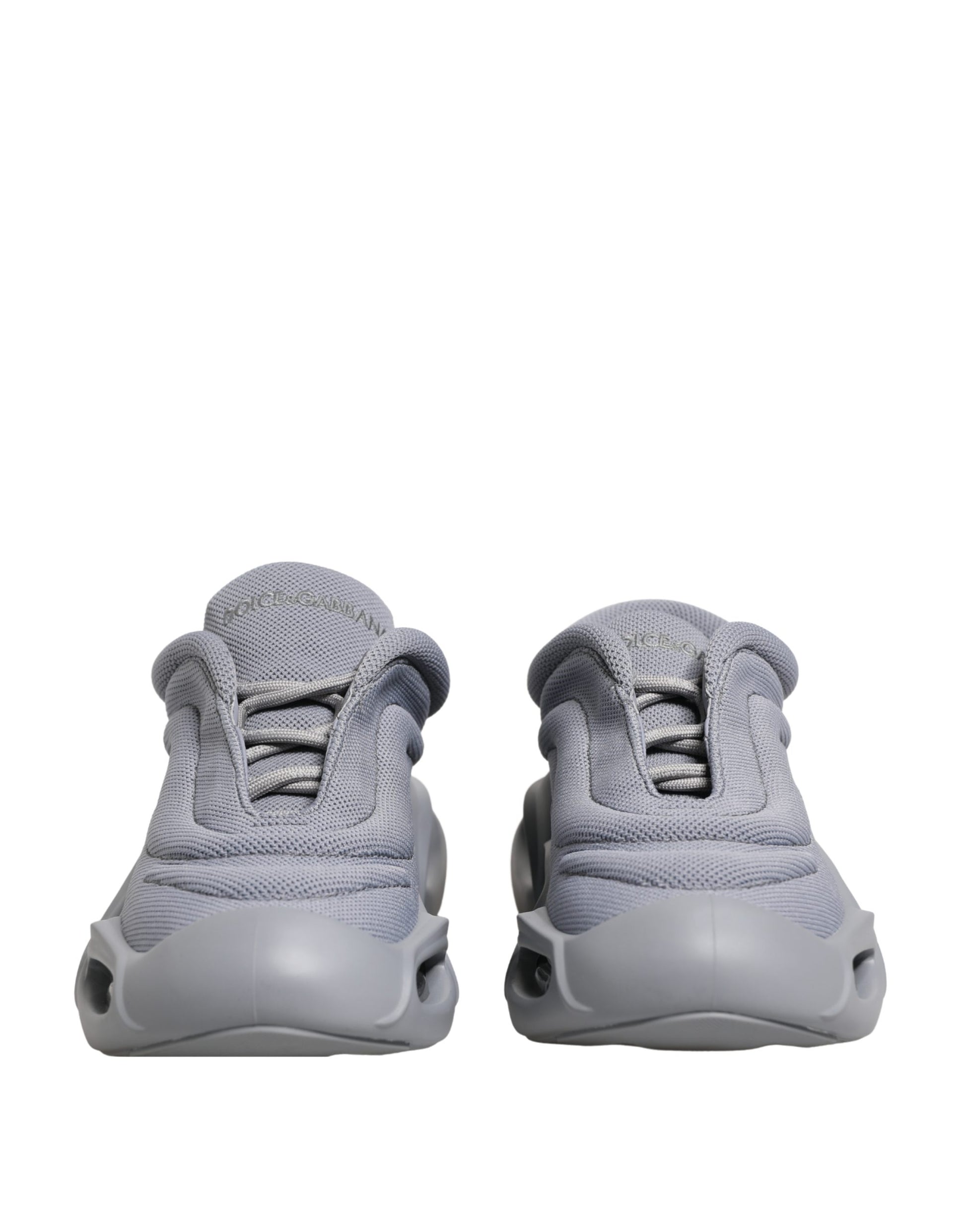 Dolce & Gabbana gray low-top sneakers in mesh and rubber, featuring a slip-on style with a chunky, futuristic sole.