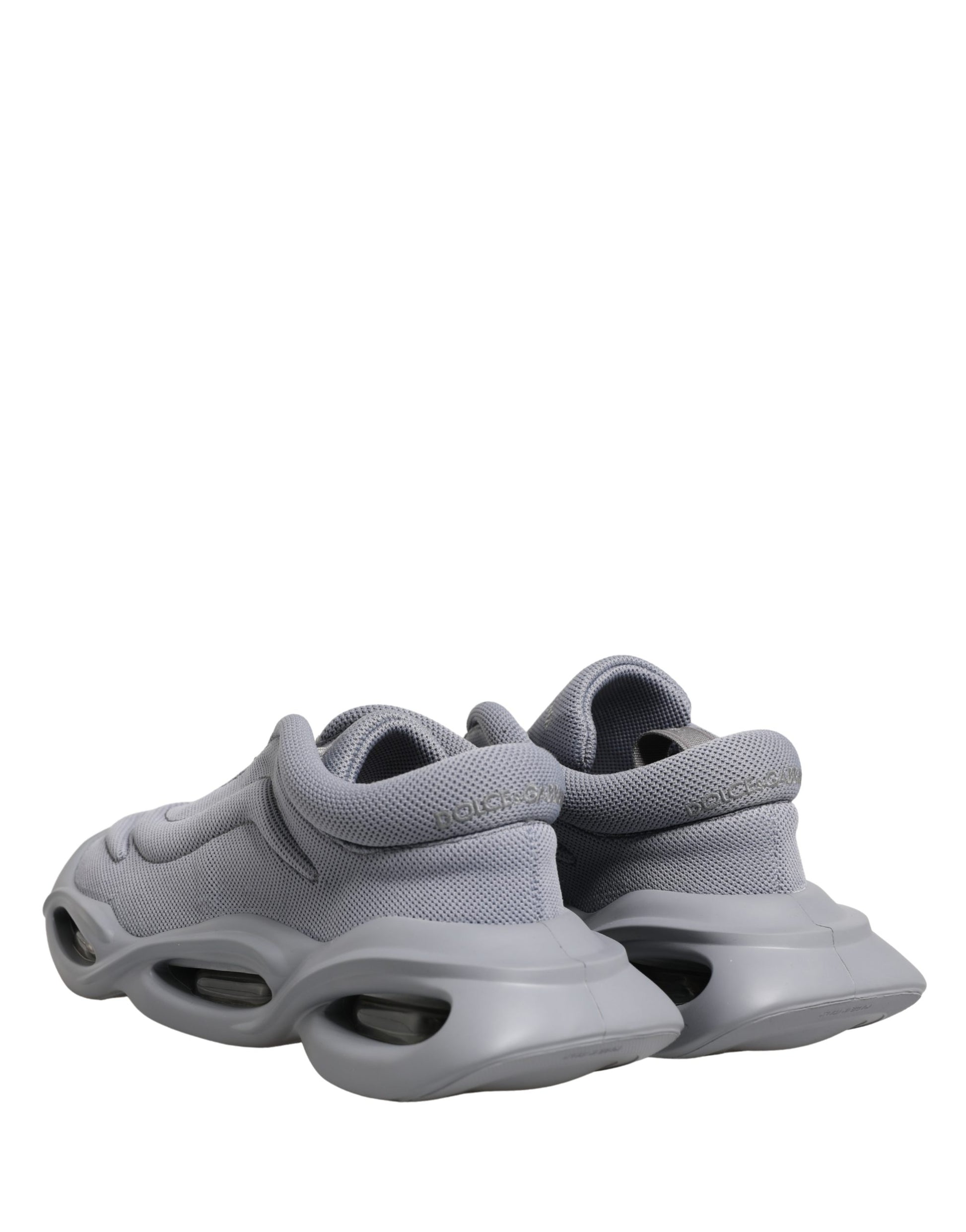 Dolce & Gabbana gray slip-on low-top sneakers in textured mesh with a chunky, architectural rubber wave sole.