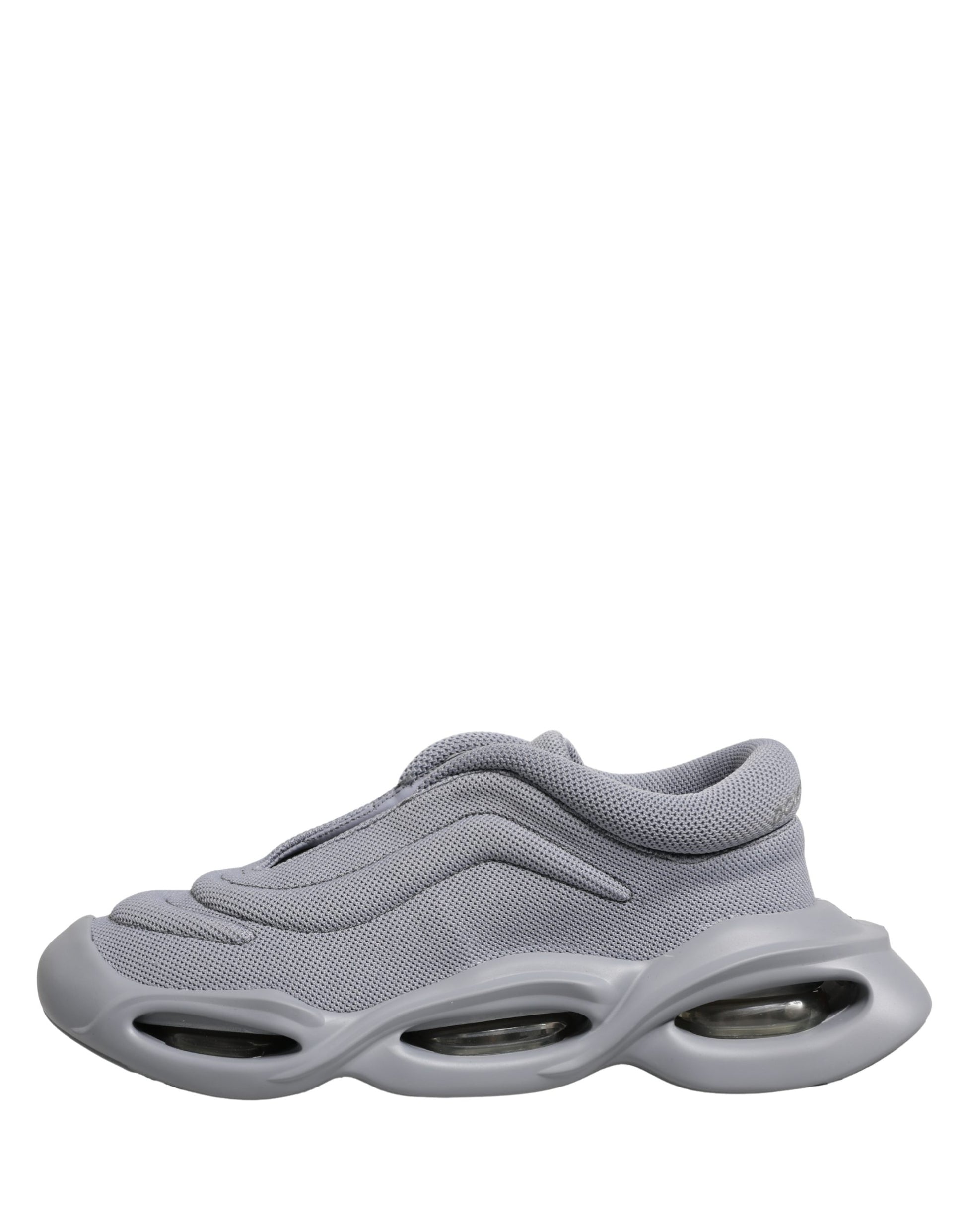 Dolce & Gabbana gray low-top slip-on sneakers featuring a textured knit upper and a chunky, futuristic wave sole.