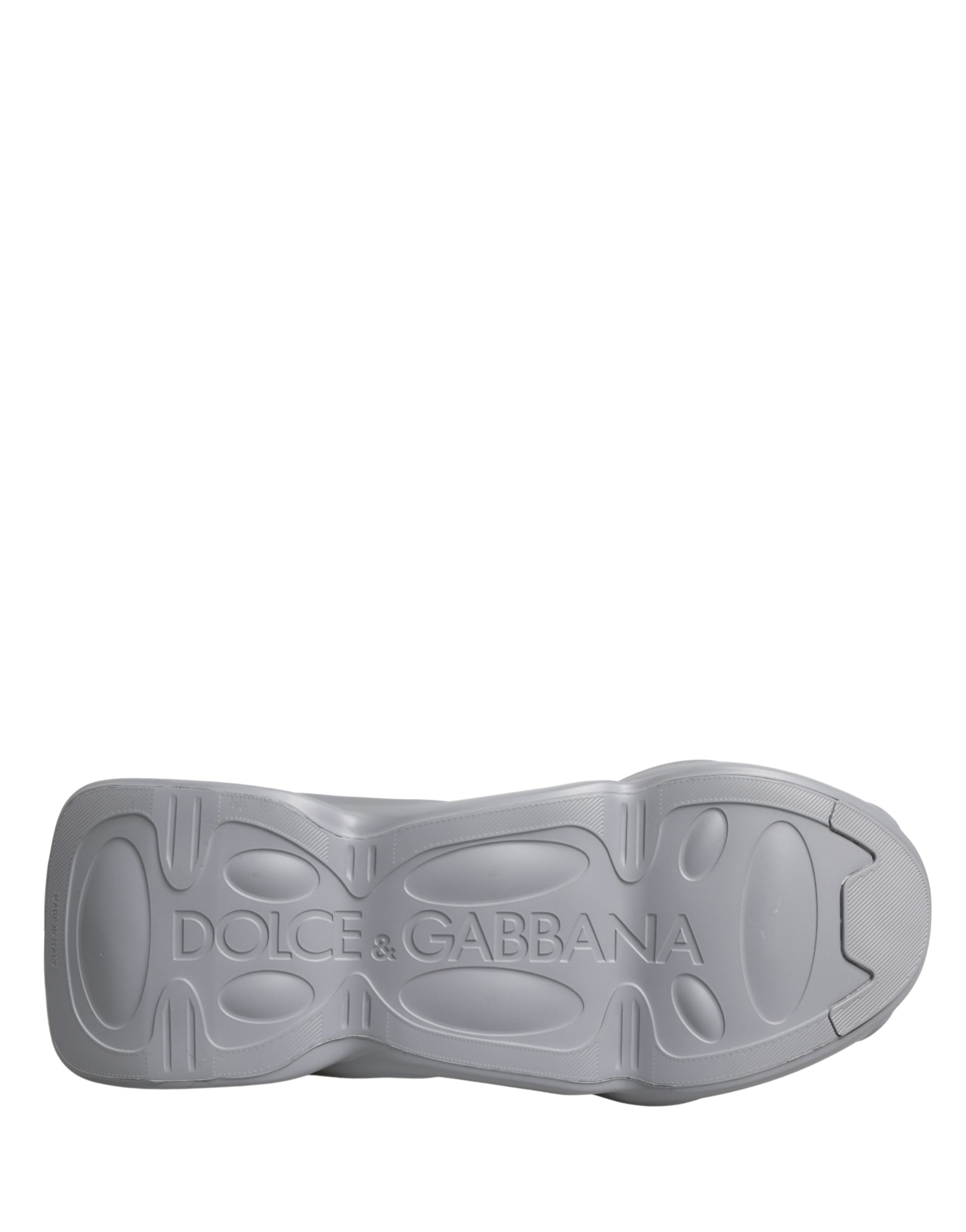 Gray Dolce & Gabbana slip-on sneaker, showing the textured rubber sole with embossed branding.