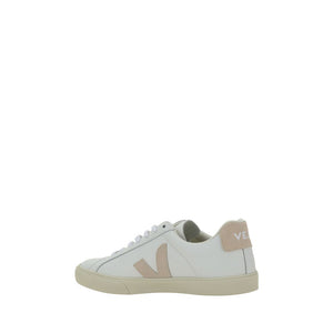 Veja white leather low-top sneaker with beige V logo and heel tab, white laces, and flat rubber sole.