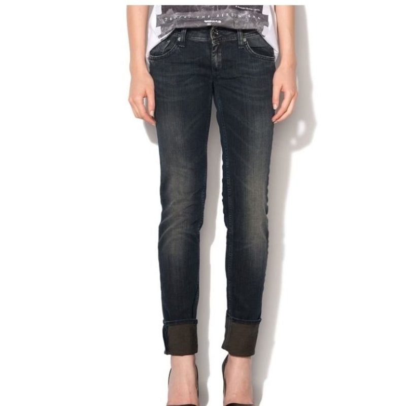 Dark wash cotton skinny jeans with cuffed hems worn by a model
