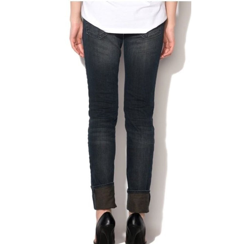 Dark denim cotton skinny jeans with cuffed hems viewed from the back