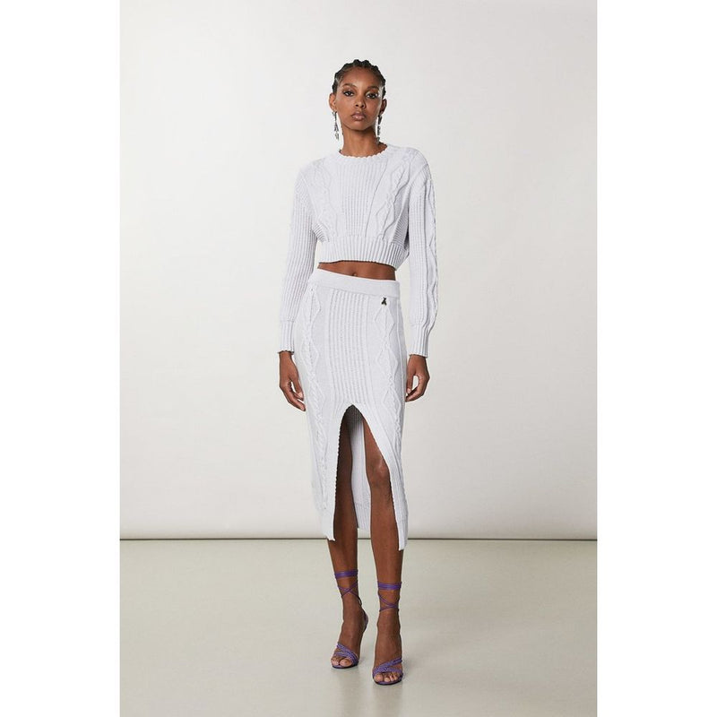 White cable knit viscose midi skirt with a high front slit worn by a model