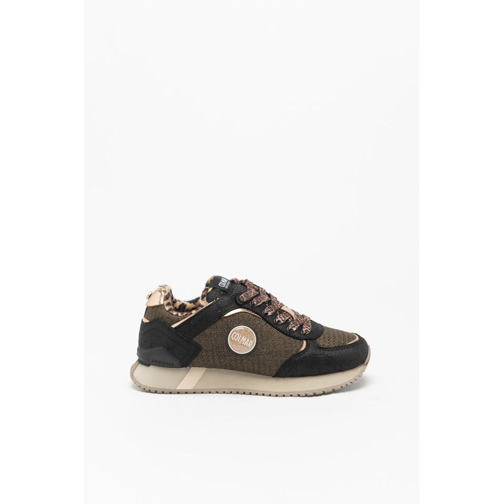 Female model wearing Colmar bicolor polyethylene sneakers with a bold two-tone upper, sporty low-profile silhouette, and lightweight construction, captured mid-step in a casual lifestyle pose showcasing the sneaker's striking color contrast and active everyday style.