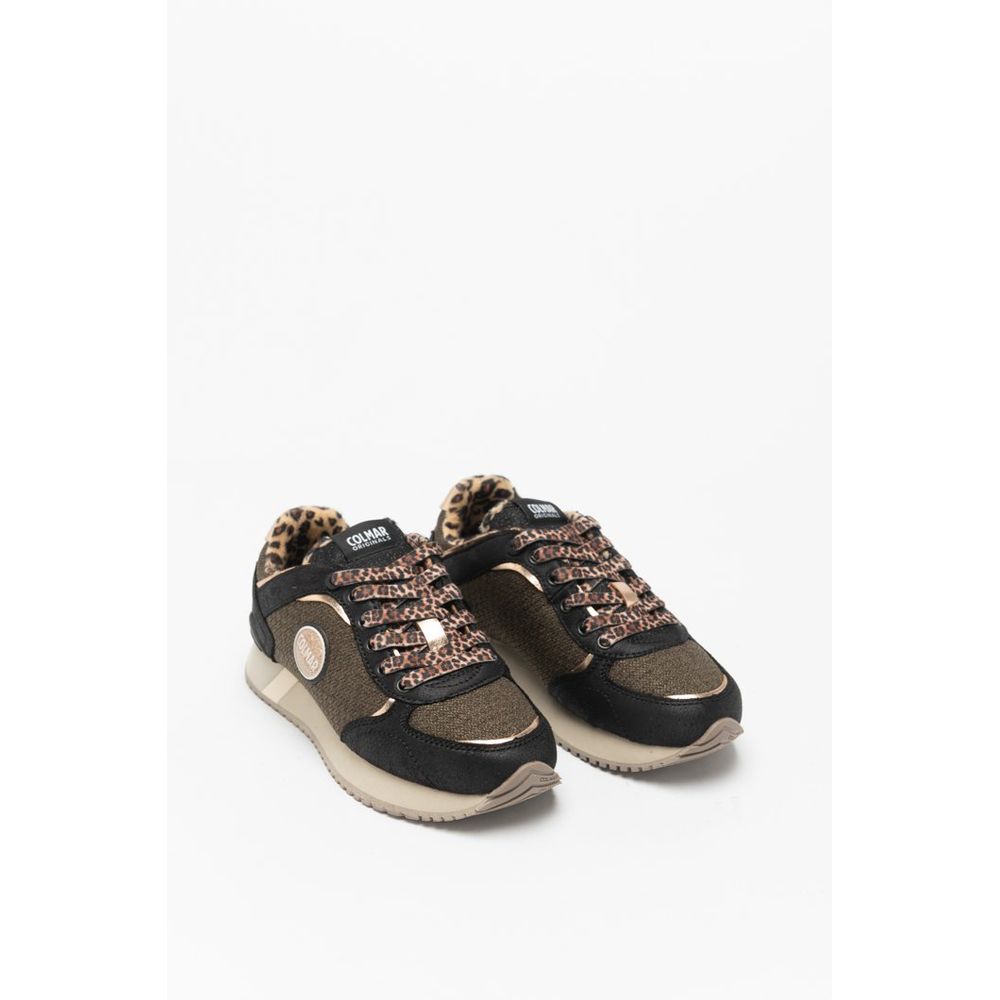 Female model wearing Colmar bicolor polyethylene sneakers with a bold two-tone upper, sporty low-profile silhouette, and lightweight construction, captured mid-step in a casual lifestyle pose showcasing the sneaker's striking color contrast and active everyday style.