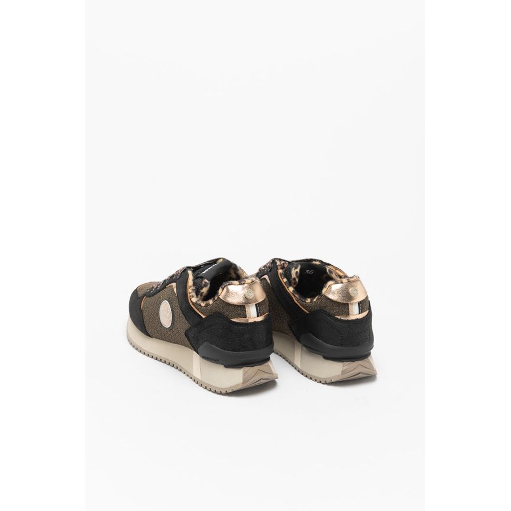 Female model wearing Colmar bicolor polyethylene sneakers with a bold two-tone upper, sporty low-profile silhouette, and lightweight construction, captured mid-step in a casual lifestyle pose showcasing the sneaker's striking color contrast and active everyday style.