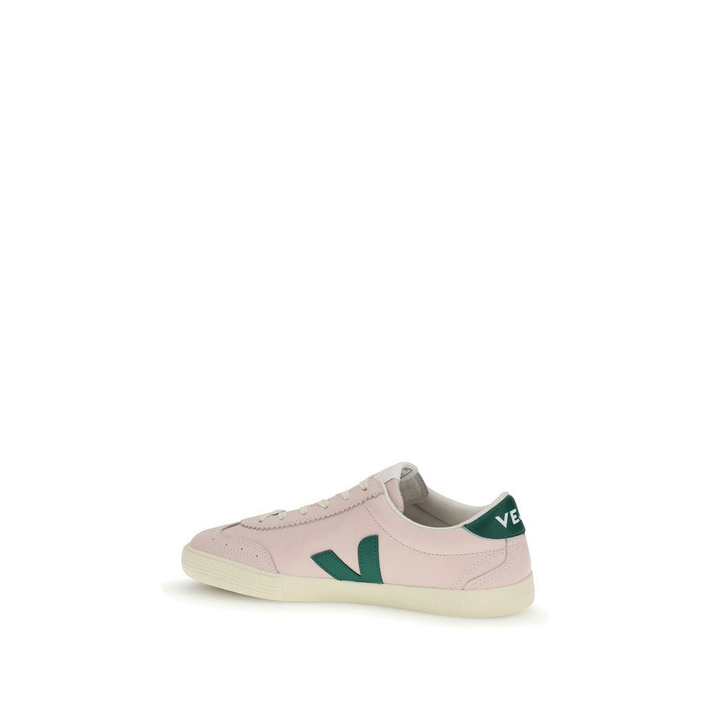 Veja pale pink calf leather low-top sneakers with forest green V logo and heel tab on an off-white rubber sole.