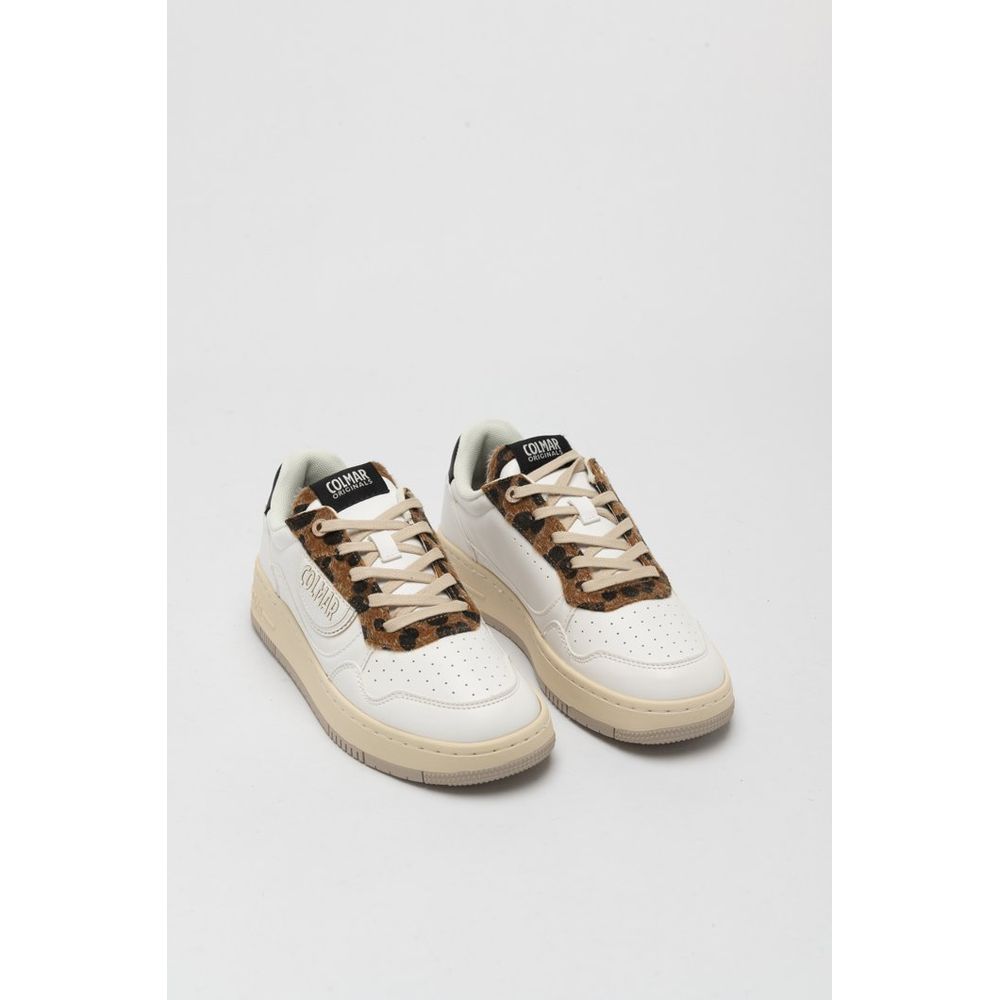 White sneakers with brown accents on a light gray background