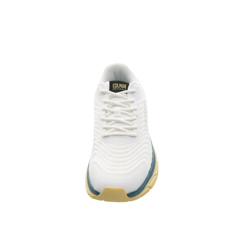Female model wearing Colmar bicolor polyester athletic sneakers with a bold two-tone upper, sporty athletic silhouette, and lightweight performance construction, captured mid-step in a casual lifestyle pose showcasing the sneaker's dynamic color contrast and active sport style.