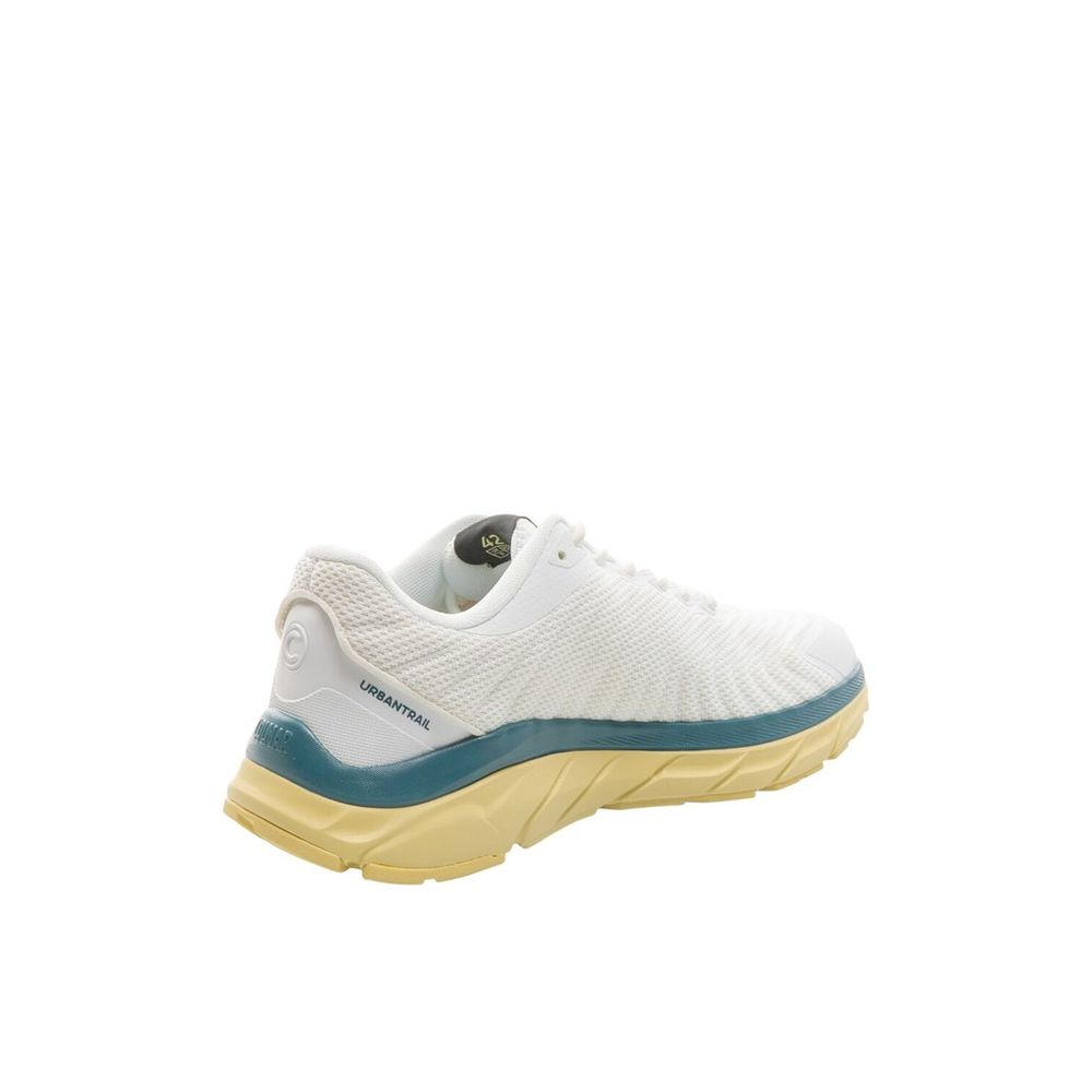 Female model wearing Colmar bicolor polyester athletic sneakers with a bold two-tone upper, sporty athletic silhouette, and lightweight performance construction, captured mid-step in a casual lifestyle pose showcasing the sneaker's dynamic color contrast and active sport style.