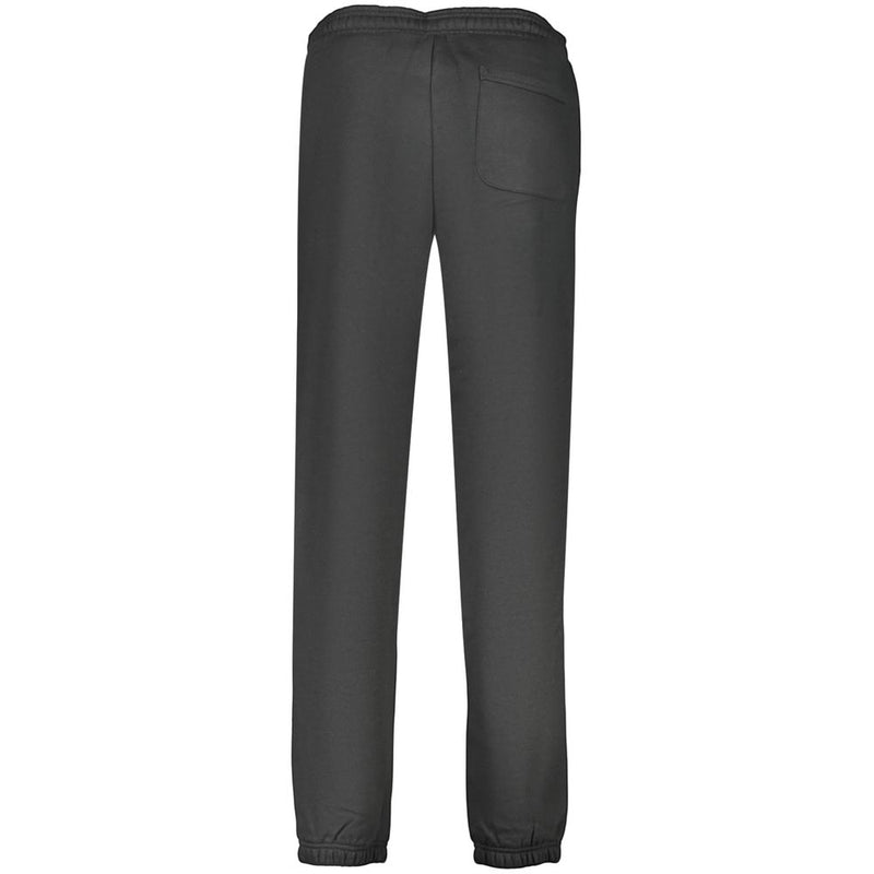 Black cotton women's sweatpants viewed from behind, featuring an elastic waistband, cuffed hems, and a back pocket
