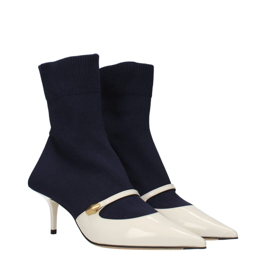 Navy blue knit sock boots with cream-colored patent leather pointed toes, Mary Jane strap, and gold metal hardware.