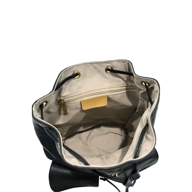 Open top view of a black leather bucket-style backpack with light-colored fabric lining and drawstring closure