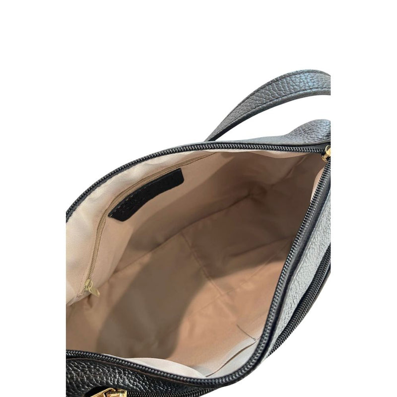 Interior view of an open black leather crossbody bag showing light beige lining and a zipper pocket