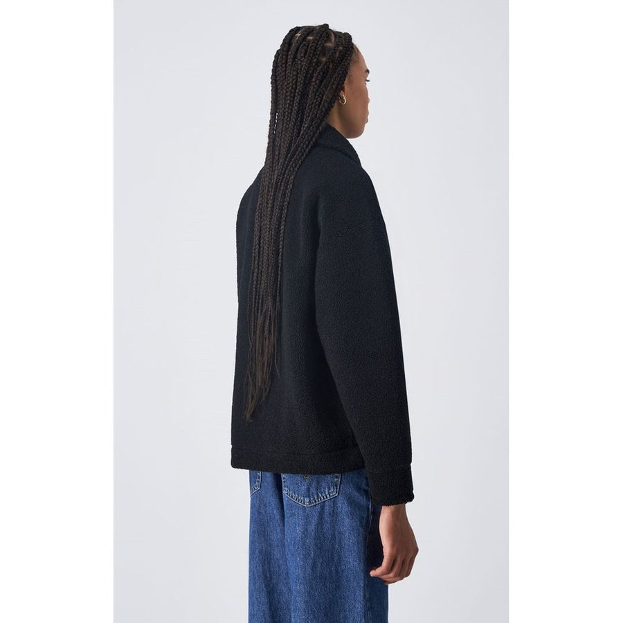 Black fleece zip-up jacket with collar and chest pocket worn by a model