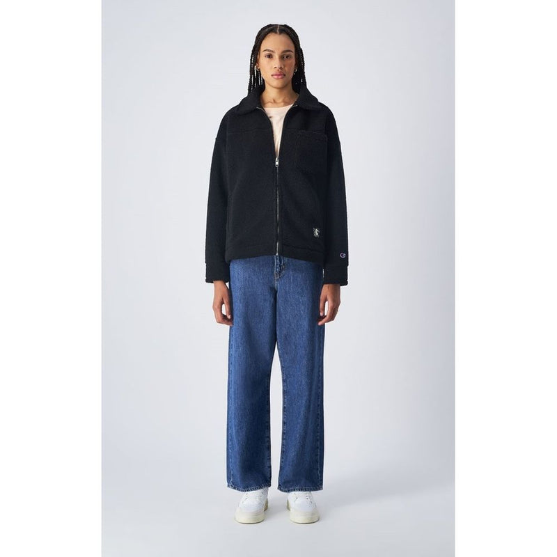 Champion black polyester fleece zip-up jacket worn with blue jeans