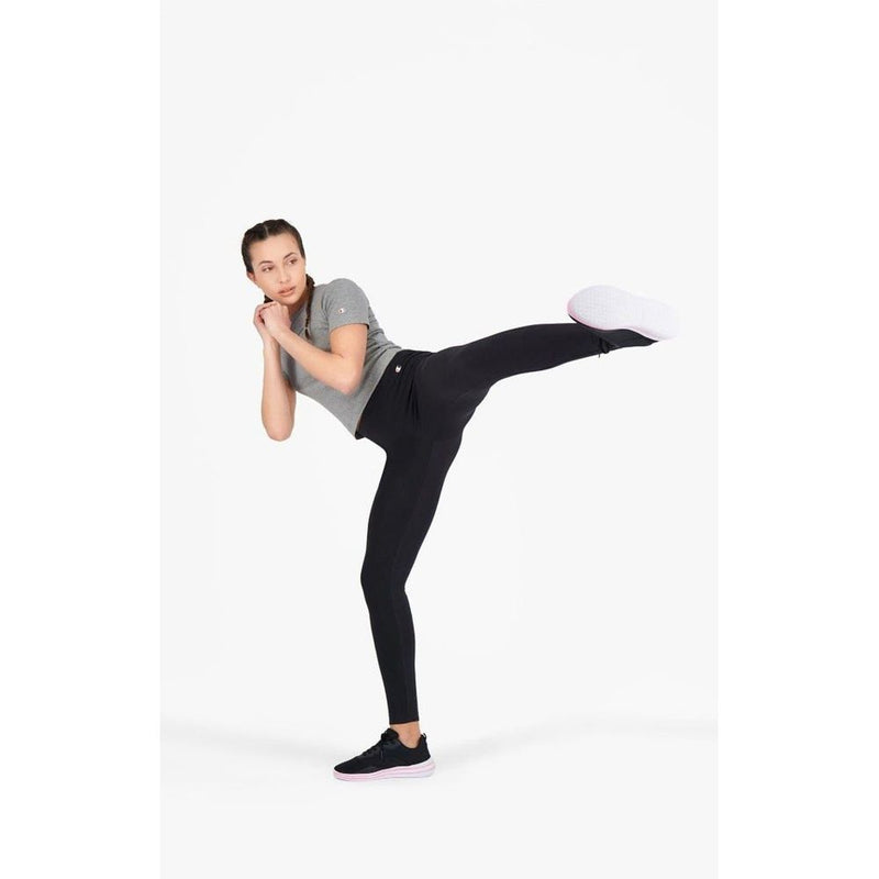 Black cotton ankle-length leggings worn by a woman kicking