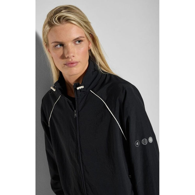 Black polyamide zip-up sweatshirt with white piping and high collar worn by a blonde woman