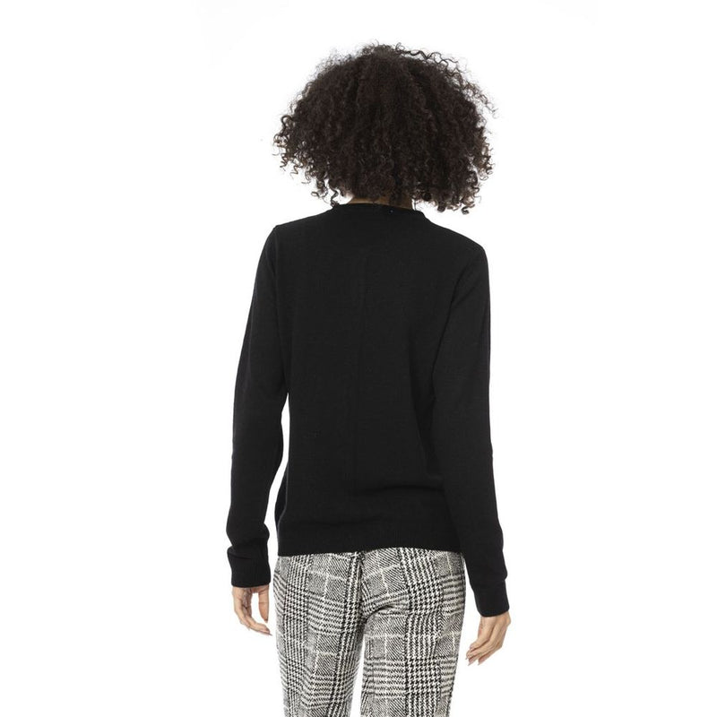 Back view of a plain black knit wool cardigan worn by a woman