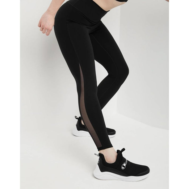 Champion black polyester leggings with sheer mesh side panels worn with black sneakers