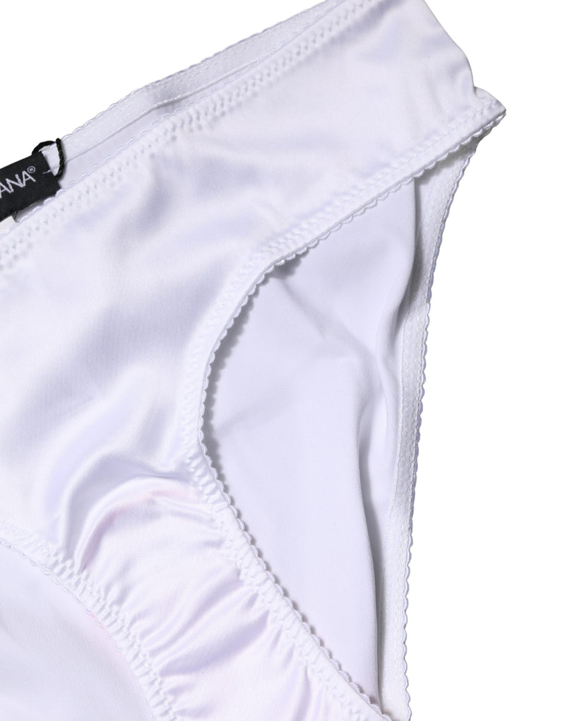 White silk stretch brief panty with scalloped trim and a black designer tag