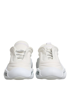 White Dolce & Gabbana low-top slip-on sneakers with a chunky wave-shaped rubber sole and textured mesh fabric upper.