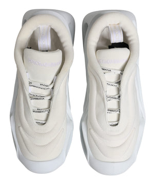 Dolce & Gabbana white mesh low-top sneakers with a wavy rubber sole, slip-on style, and branded ribbon details.