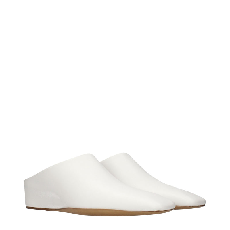 White leather slip-on shoes with thin brown soles