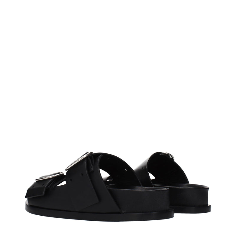 Black leather slip-on sandals with flat soles and silver buckles