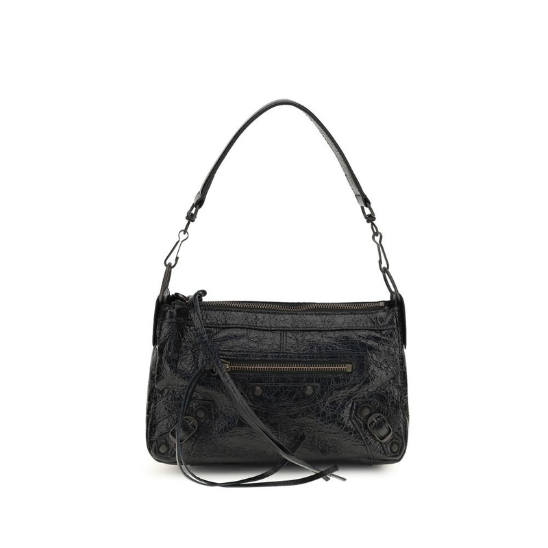 Black crumpled leather handbag with a shoulder strap, zipper pockets, and metal hardware