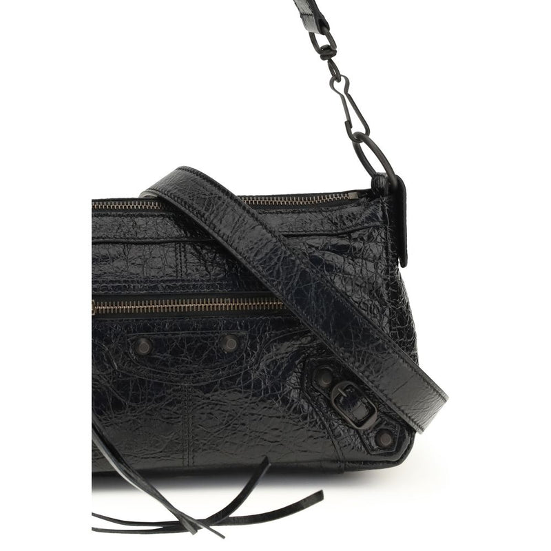 Black crinkled leather handbag with zippered pockets, studs, and a strap